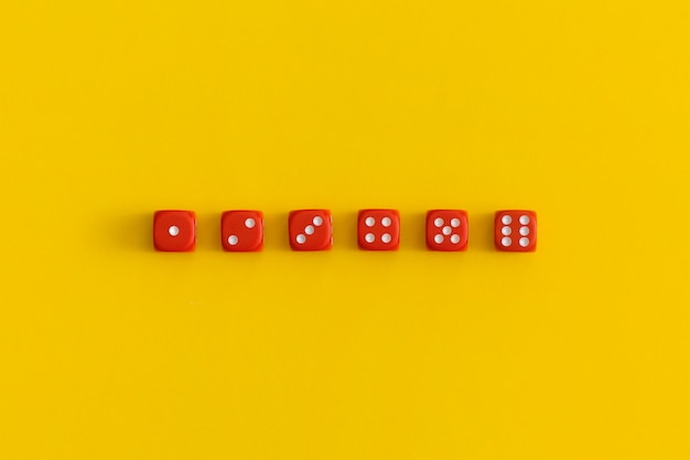 Red gaming dices on yellow background. Game concept