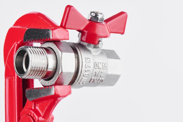 Red gas key and valve for sanitary equipment on the white background. Plumbing concept.