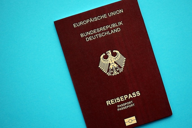 Red german passport of european union on blue background close up