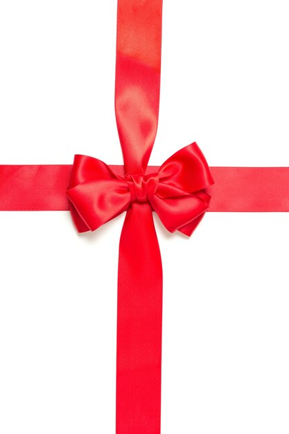 Red gift bow and crossed red ribbon isolated on white background.