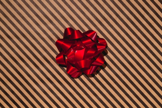 Photo red gift bow on wrapping paper high quality photo
