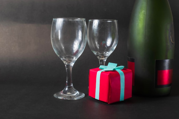 Red Gift Box and Champagne Glass on Black Background Valentines Day