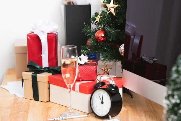 Red gift box in christmas holiday at the office with christmas decoration on table.