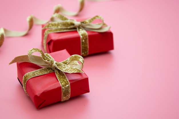 Red gift box and golden bow for Christmas or Birthday.