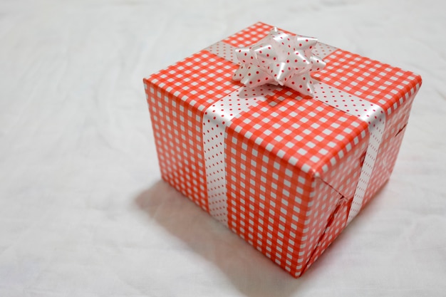 Red Gift box on the gray cloth for Christmas.