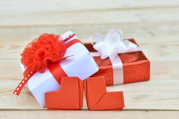 Red gift box and heart shape on wooden