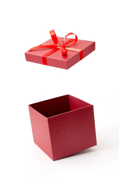 Photo red gift box open with ribbon isolated on white background