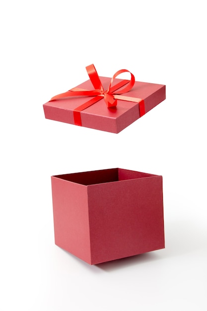 Red gift box open with ribbon isolated on white background