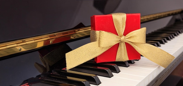 Red gift box on piano keyboard