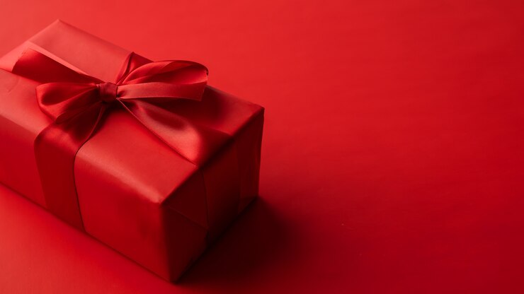 Photo red gift box on red background, valentine's day gift, special occasion
