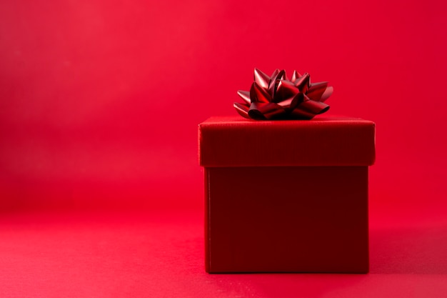 Photo red gift box on red background with copy space