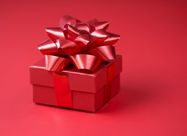 red gift box on red ribbon and red background white