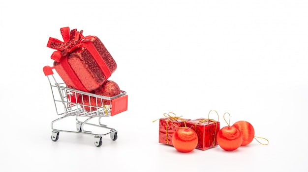 Red gift box in a shopping cart on a white background.