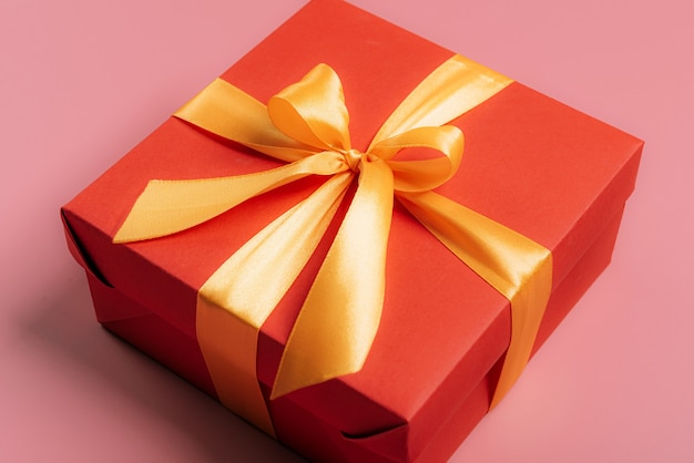 Red gift box tied with a golden ribbon