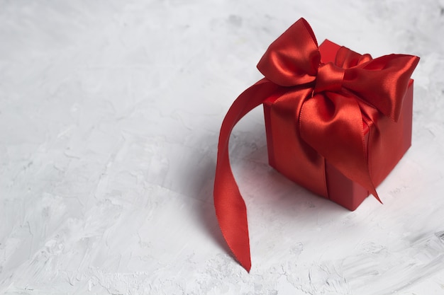 Red gift box with red satin ribbon top view