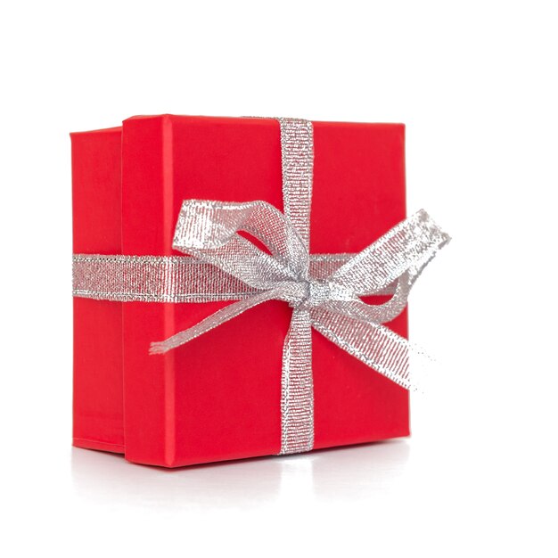 Red gift box with white ribbon isolated on white