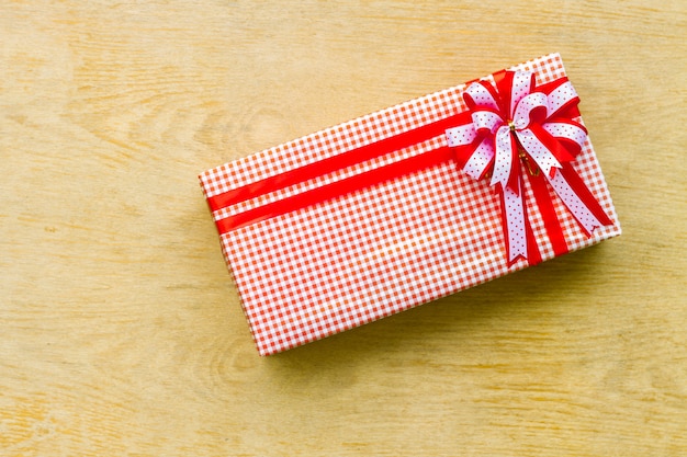 Red gift box on wooden background