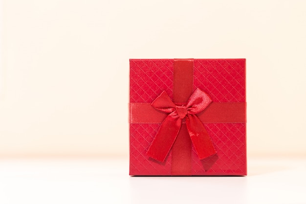 Red gift box on wooden plank. Concept for valentine day.