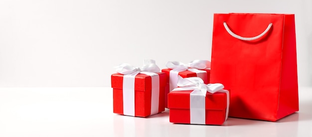 Red gift boxes and a bag on a white background