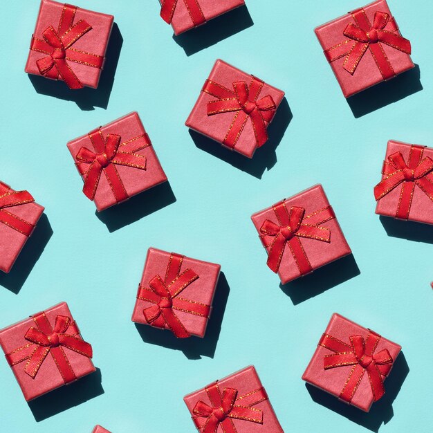 Red gift boxes over turquoise background