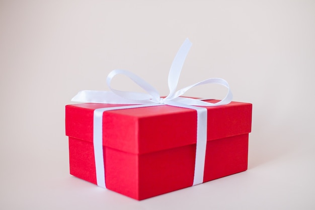 Red gift boxes of various sizes tied with a white satin ribbon