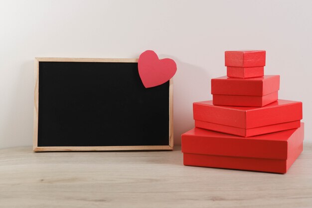Red gift boxes with blackboard and heart.