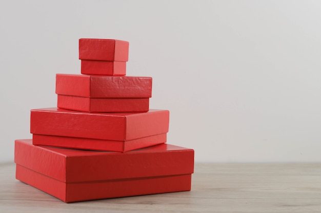 Red gift boxes on wooden table.