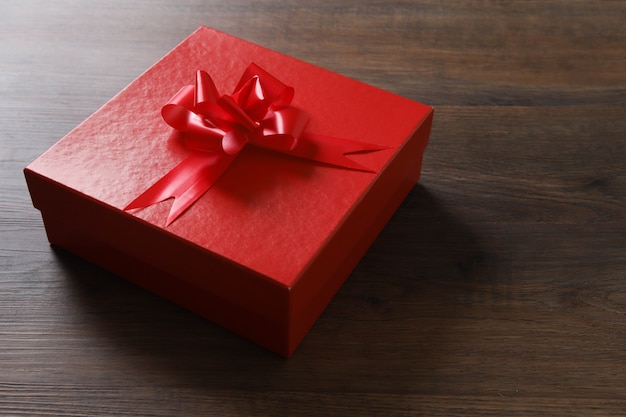 Red gift boxes on wooden table.