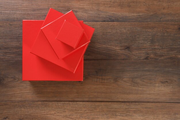 Red gift boxes on wooden table.