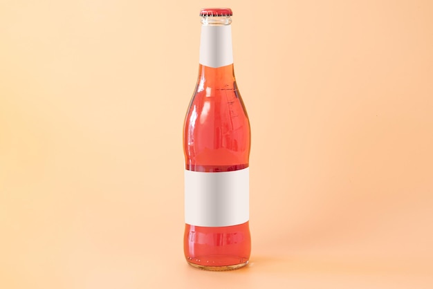 A red glass bottle of cider with white blank labels on a yellow background Fresh Traditional Light Refreshment Studio Label Trade Front Brand Label Transparent