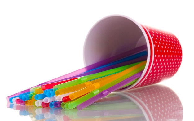 Red glass with straws isolated on white