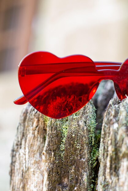 Photo red glasses in the form of hearts on a natural background