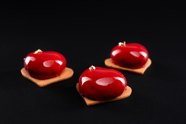 Red glazed heart cakes on cookies.