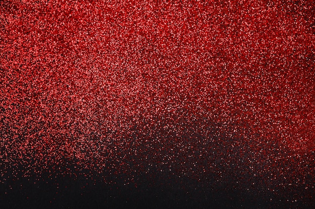 Red glitter sand isolated on black