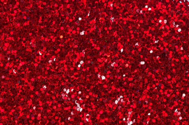 Red glitter texture for background. High resolution photo.