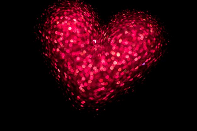 Red glowing heart on black