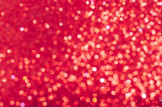 Foto paillettes rosse incandescenti sfondo sfocato