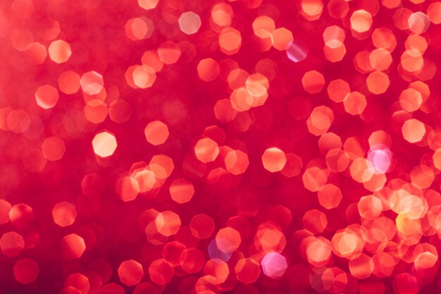 red glowing sequins blurred background