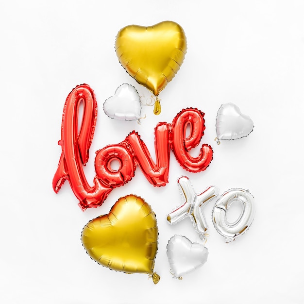 Photo red and gold  foil balloons in the shape of the word 