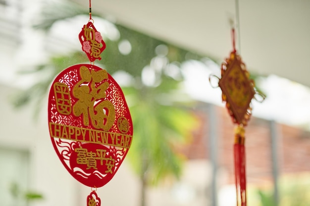 Red and gold pedants hanging on house porcch to attract luck and prosperity in new year