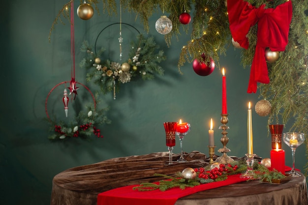 Red and golden christmas decor on table on dark background