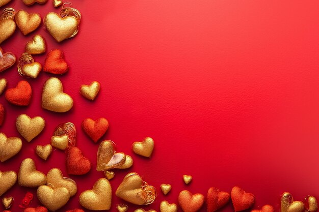 Red and golden hearts on bright red background top view copy space