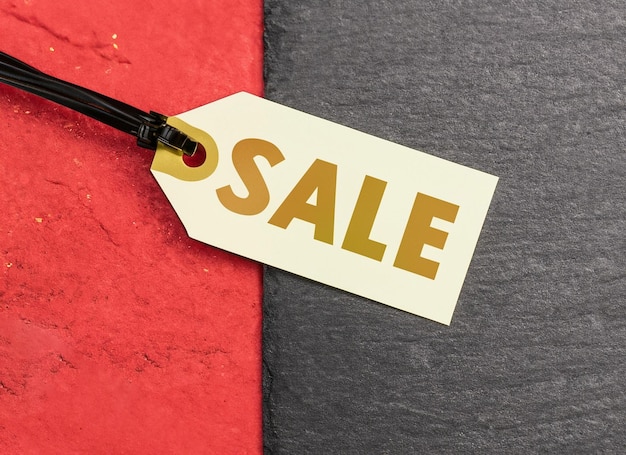 Red and golden sale tag on dark background