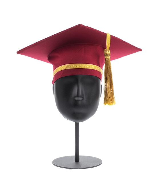 red graduation cap on mannequin isolated on white background