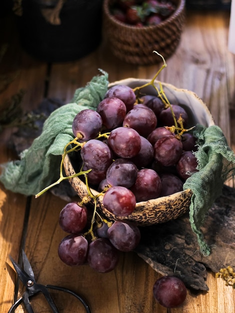 Red Grape Fruits in bowl on wooden table. Stilllife concept