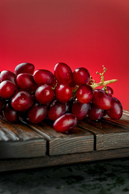 Red grapes on a wooden board