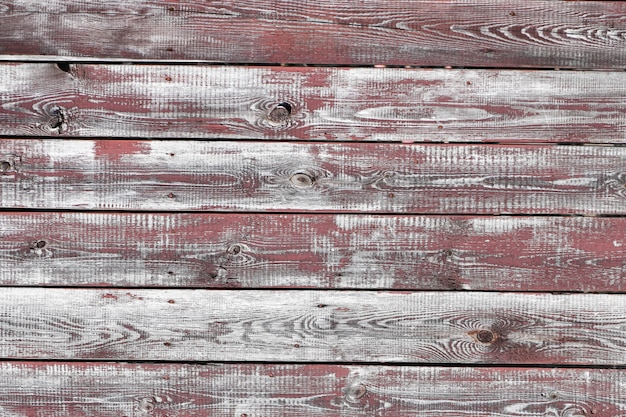 Red-gray wooden background. horizontal boards. old paint peels off. old boards. Red gray wood texture of a worn painted board. Red gray wood texture of old worn painted board