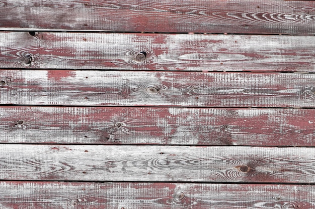 Red-gray wooden background. horizontal boards. old paint peels
off. old boards. red gray wood texture of a worn painted board. red
gray wood texture of old worn painted board