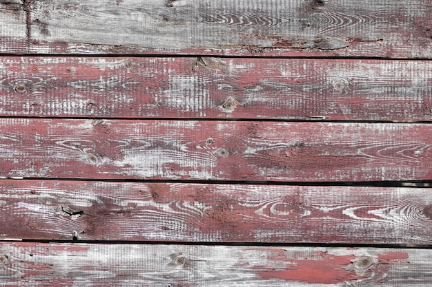 Red-gray wooden background. horizontal boards. old paint peels off. old boards. Red gray wood texture of a worn painted board. Red gray wood texture of old worn painted board