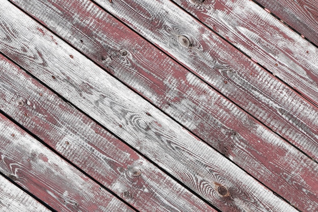 Red-gray wooden background. horizontal boards. old paint peels off. old boards. Red gray wood texture of a worn painted board. Red gray wood texture of old worn painted board